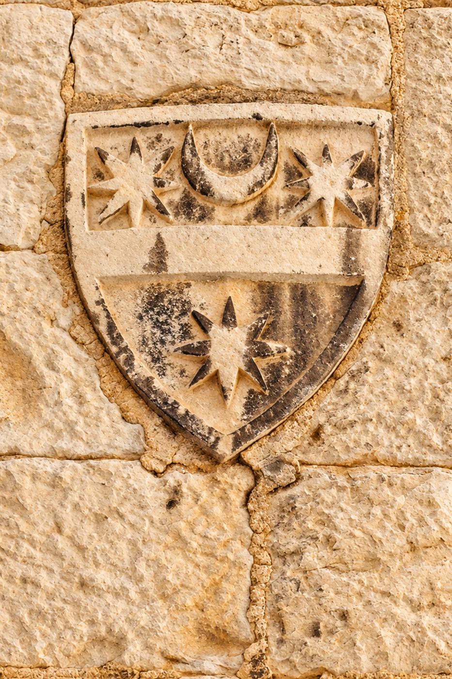 Historic stone coat of arms on the building housing Roman Heritage Apartment in Split